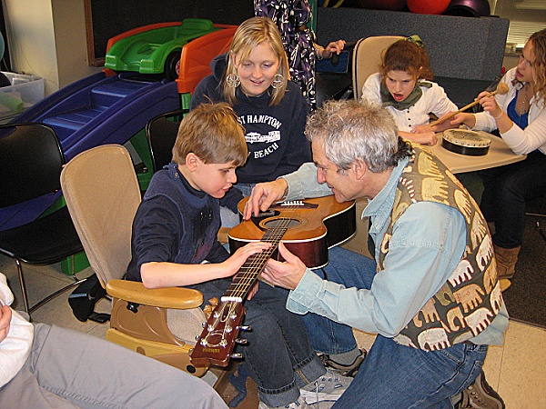 Student playing with guitar