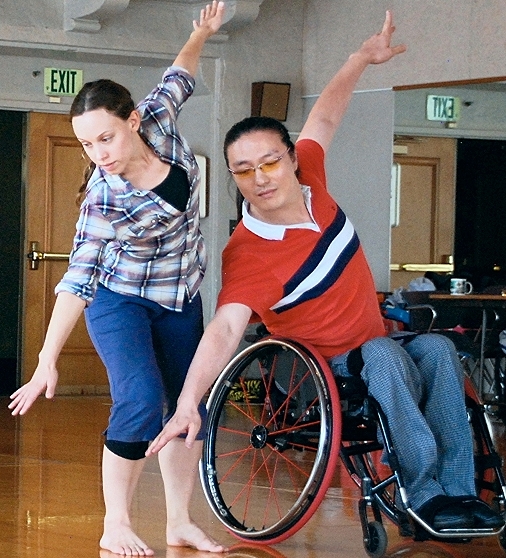 Woman dancing with wheelchaired dancer