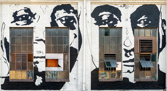 Faces painted around building windows