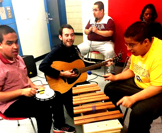 Mark Fuller and students playing musical instruments