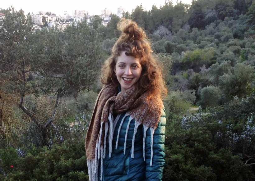 Photo of Sara Klugman outdoors with many trees in the background